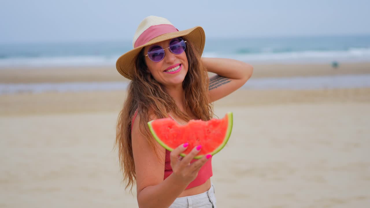 Woman with watermelon on the beach
