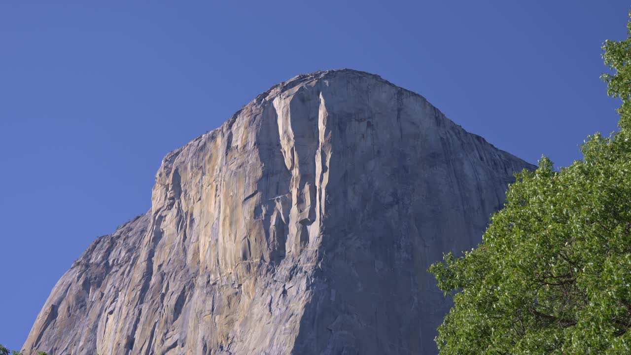Footage capturing an upward view of the towering granite face of El Capitan in Yosemite National Park, California
