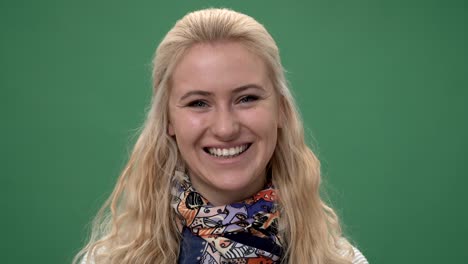 close up smiling young woman's face, chroma key green screen background
