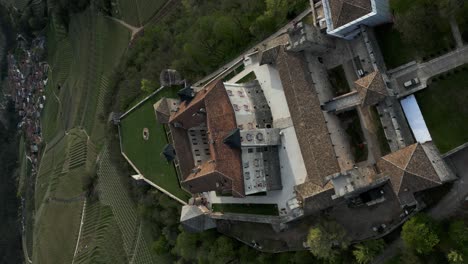 Aerial-descending-view-of-Thun-Castle,-Ton-in-Trentino-Alto-Adige,-Italy