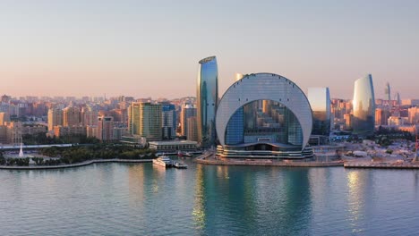 Sunset-urban-skyline-of-Baku-downtown-district-and-calm-Caspian-bay,-Azerbaijan