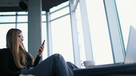 beautiful young woman while using her mobile phone.