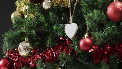 video of christmas tree with decorations and heart with copy space