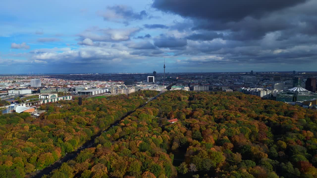 Berlin cityscape from Tiergarten park to Reichstag, Brandenburg Gate and Tv Tower. Wonderful aerial view flight fly reverse panorama overview drone