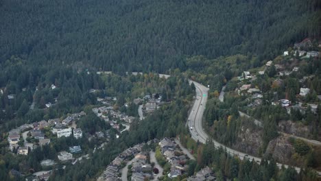 Pueblo-De-Lujo-Junto-A-La-Montaña-Con-Un-Denso-Bosque-De-Pinos-En-Vancouver,-Canadá.