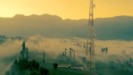 mist flowing into vast landscapes of mount bromo at sunset an aerial view, indonesia