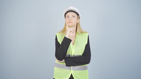 Looking-up,-the-engineer-is-holding-her-hard-hat.