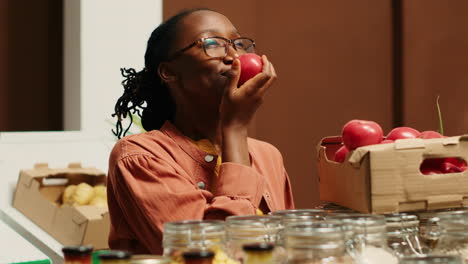 african american buyer enjoying fresh aroma of tomatoes at store