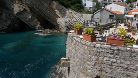 stunning old town stone cafe on a cliff with sea view, mediterranean