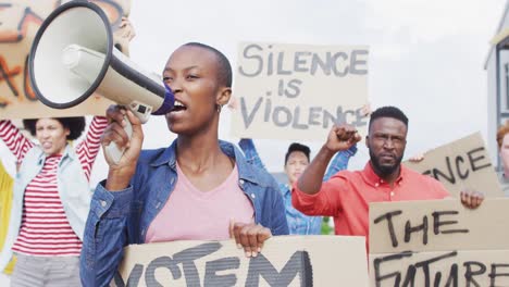 Diverse-group-of-protesters-holding-cardboard-banners-and-screaming