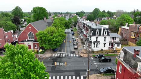 flyover of city street. rainy, wet day in spring. houses and church in downtown.