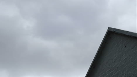 time lapse of clouds passing over building