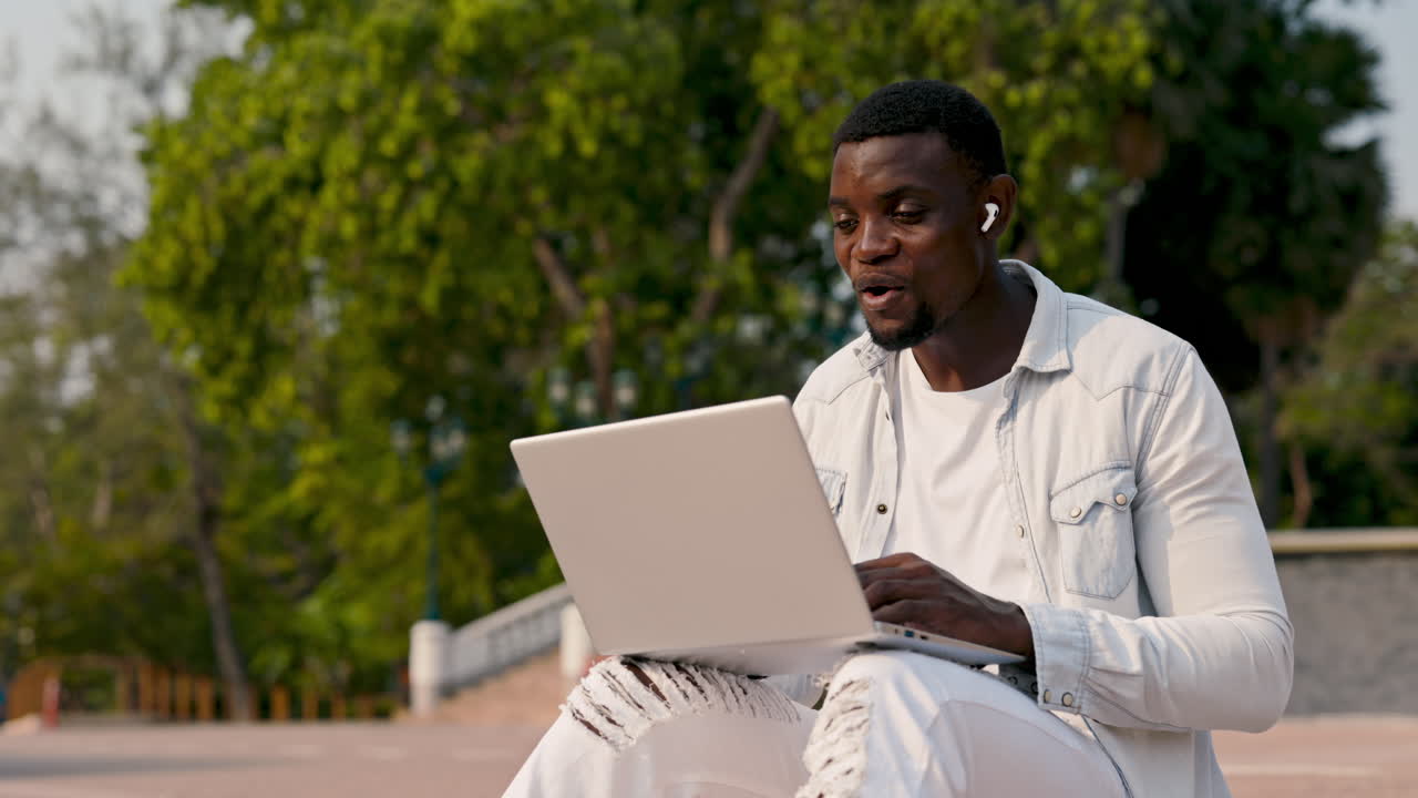 Man working on a laptop in a park