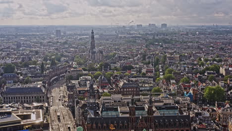 Amsterdam-Netherlands-Aerial-v42-pull-out-shot-away-from-westertoren-church-at-grachtengordel,-flyover-raadhuisstraat-street-leading-to-royal-palace,-dam-square-and-national-monument---August-2021