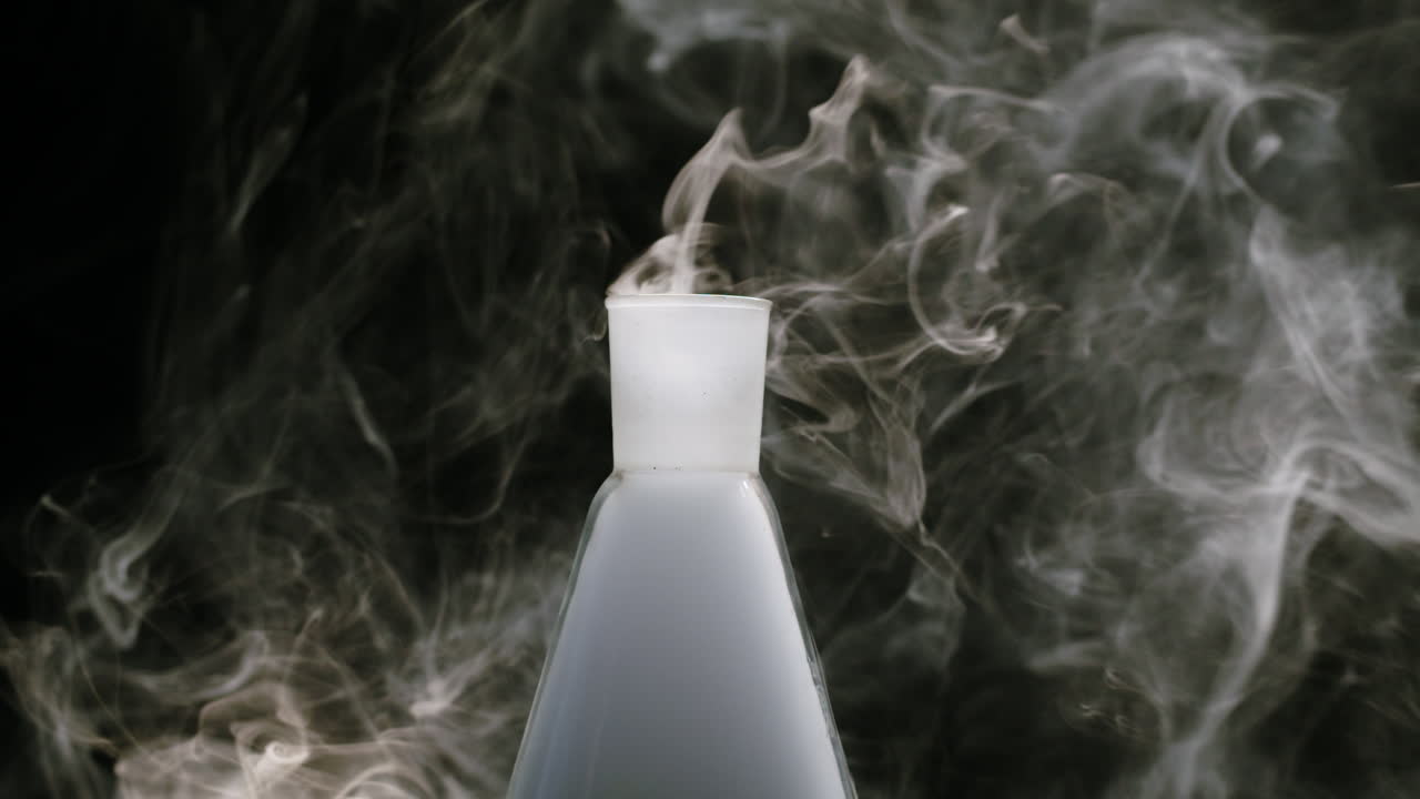 White Smoke Rising from Laboratory Flask on Black Background