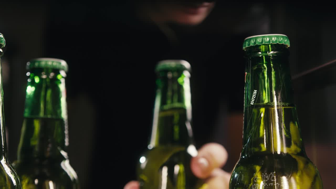 Row of beer bottles in fridge, shop or hotel, cold lager craft german beer or cider, shop supermarket or wine cooler close up.