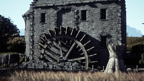 a stone watermill in a rural setting