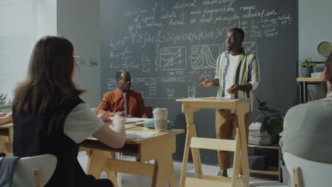 student giving a presentation in a university classroom