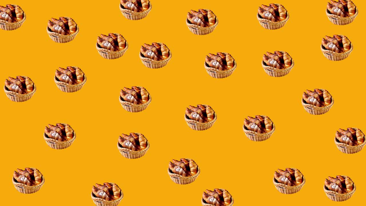 seamless looping animation with fresh pastries and french croissants covered by powdered sugar in a rustic basket wiggle on a yellow background