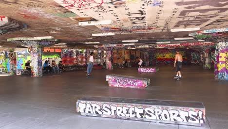 skateboarders performing tricks in urban skatepark