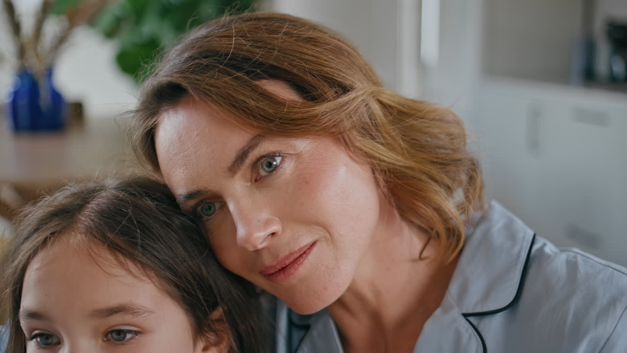 Gentle woman bonding daughter enjoying at couch closeup. Mother embracing child