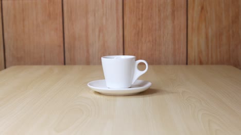 a cup remains still on a table