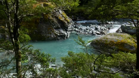 slowly floating tropical river surrounded by rocky shore and trees in national park