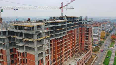 construction site of modern skyscraper. aerial side view on a new high-rise building in a new residential complex of a megacity.