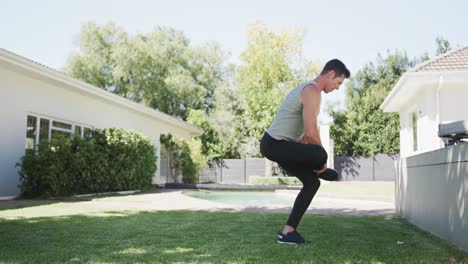 caucasian man practicing yoga in sunny garden, with copy space, slow motion