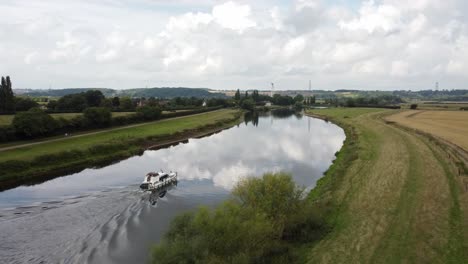 drone video rotates around a river boat sailing along the river trent in nottinghamshire