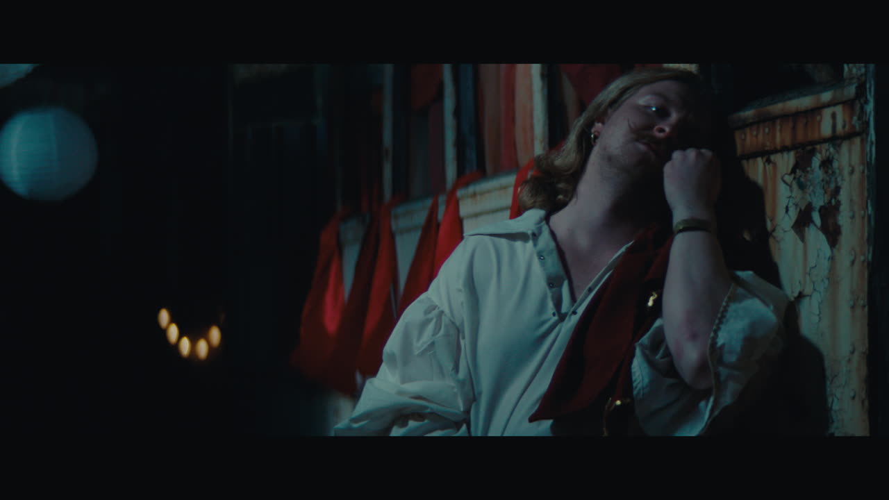 A man witch mustache in the empty gypsy circus camp at night