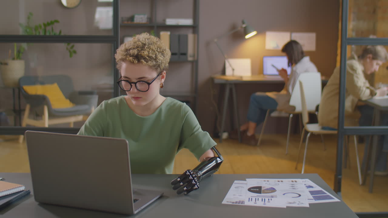 Businesswoman with Prosthetic Arm Working in Office