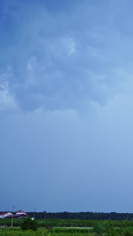 real flashes of lightning on the blue sky background. the blue sky changes its color into orange after the bright lightning. vertical video