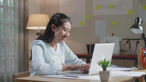 asian woman bag designer with layout bond using laptop at the office