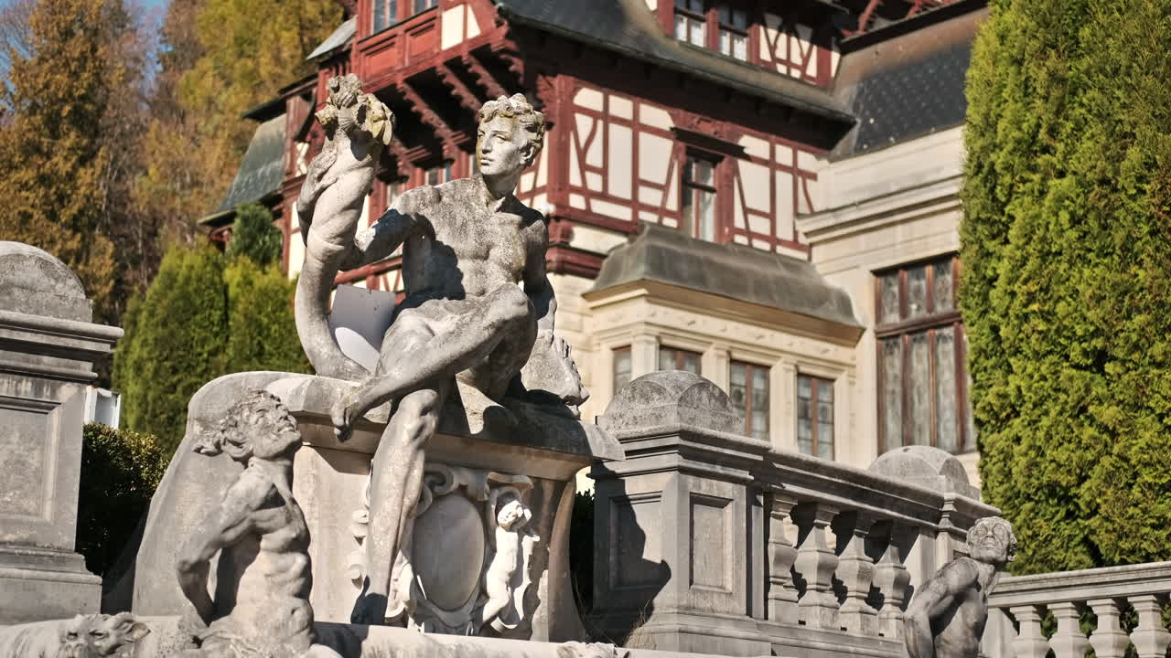 Vertical view of a sculpture at The Peles Castle in Romania. Castle on the background, tourists