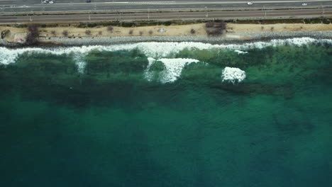 aerial view of coastal highway and ocean waves
