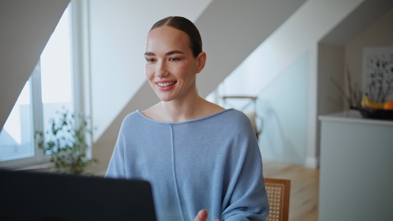 Online consultant greeting laptop webcam waving hand at home workplace closeup