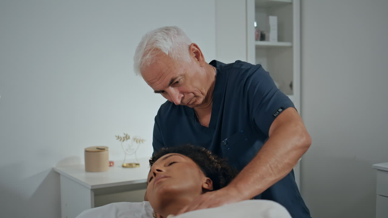 Physiotherapist cure patient disease with manual massage. Focused man pressing