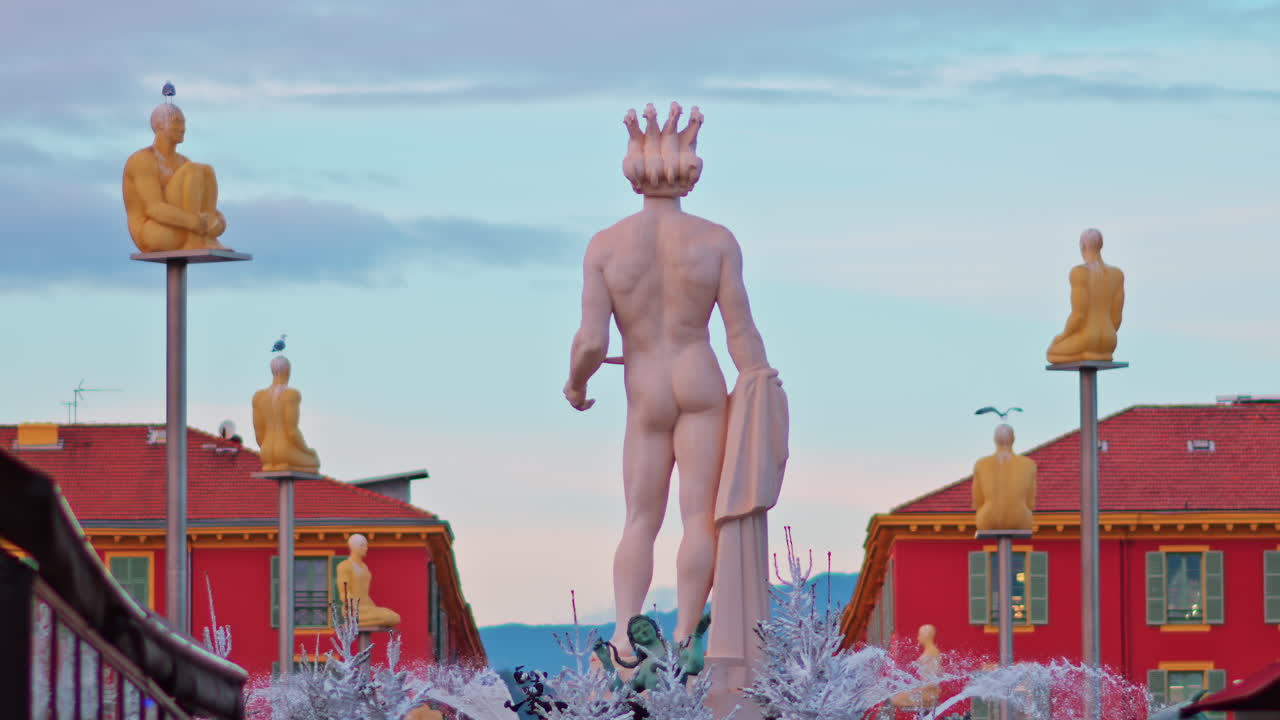 Nice, France - December 8, 2024: View of the Apollo statue in the Fontaine du Soleil at Place Massena decorated for Christmas