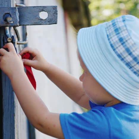 a funny country girl plays with an old lock in the barn