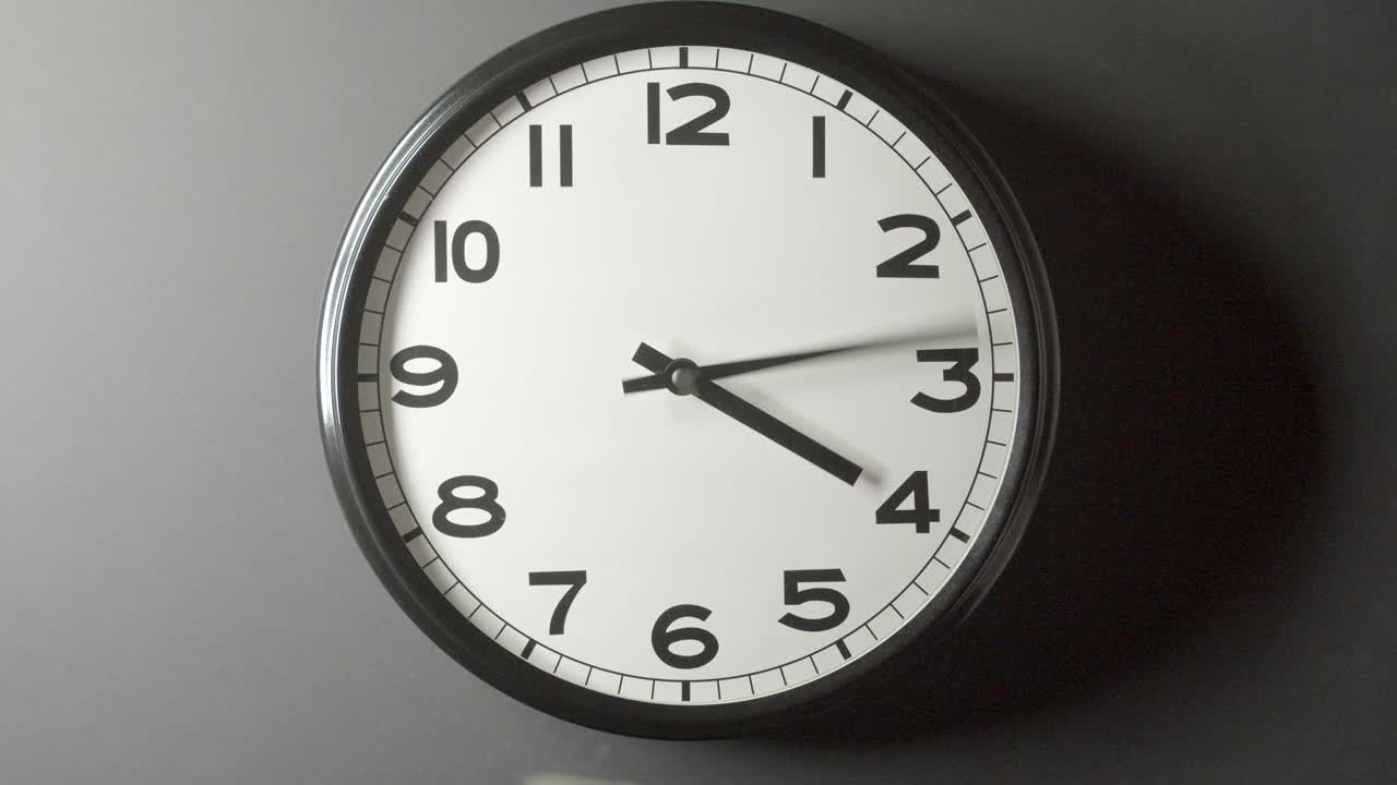 Dolly Out of White Clock Face Close Up in Time Lapse on Dark Grey Wall