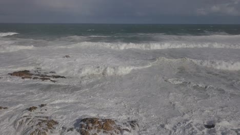 ascending aerial: violent and chaotic shore break from indian ocean