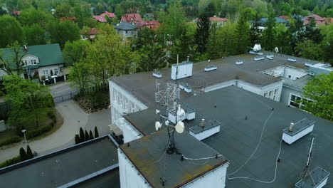 aerial view of a roof of a school building with cellular network antennas