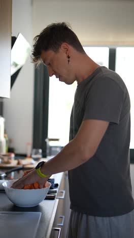 man preparing carrots in a kitchen