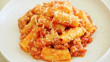 bolognese rigatoni pasta with cheese - traditional italian pasta