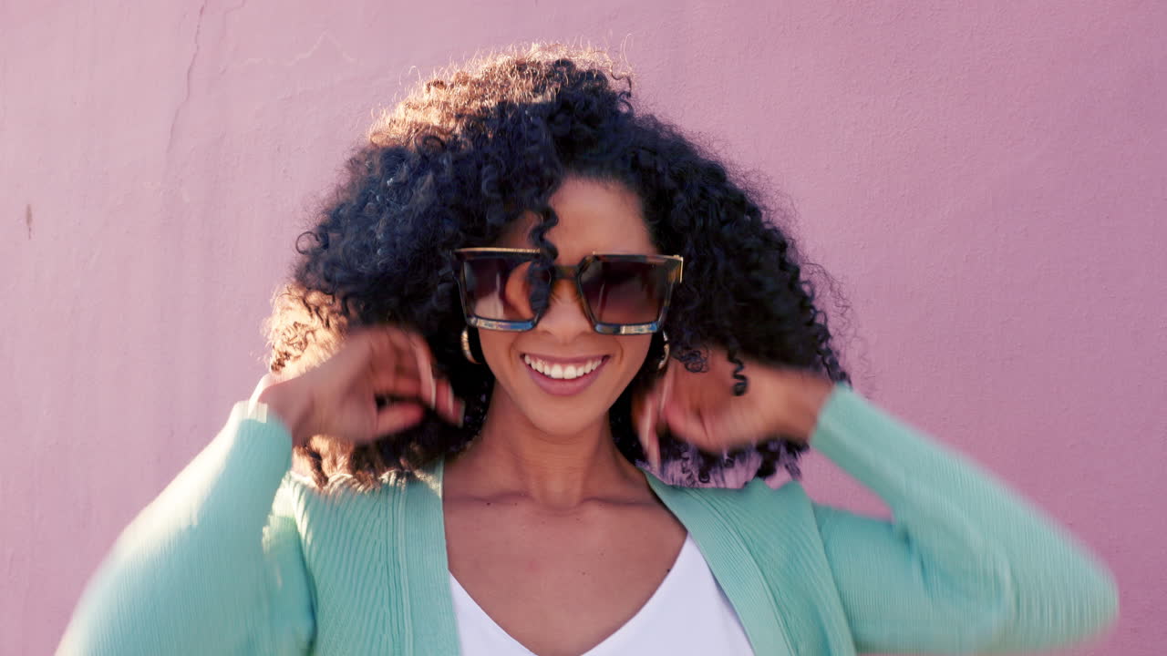 Smiling Woman with Curly Hair and Sunglasses