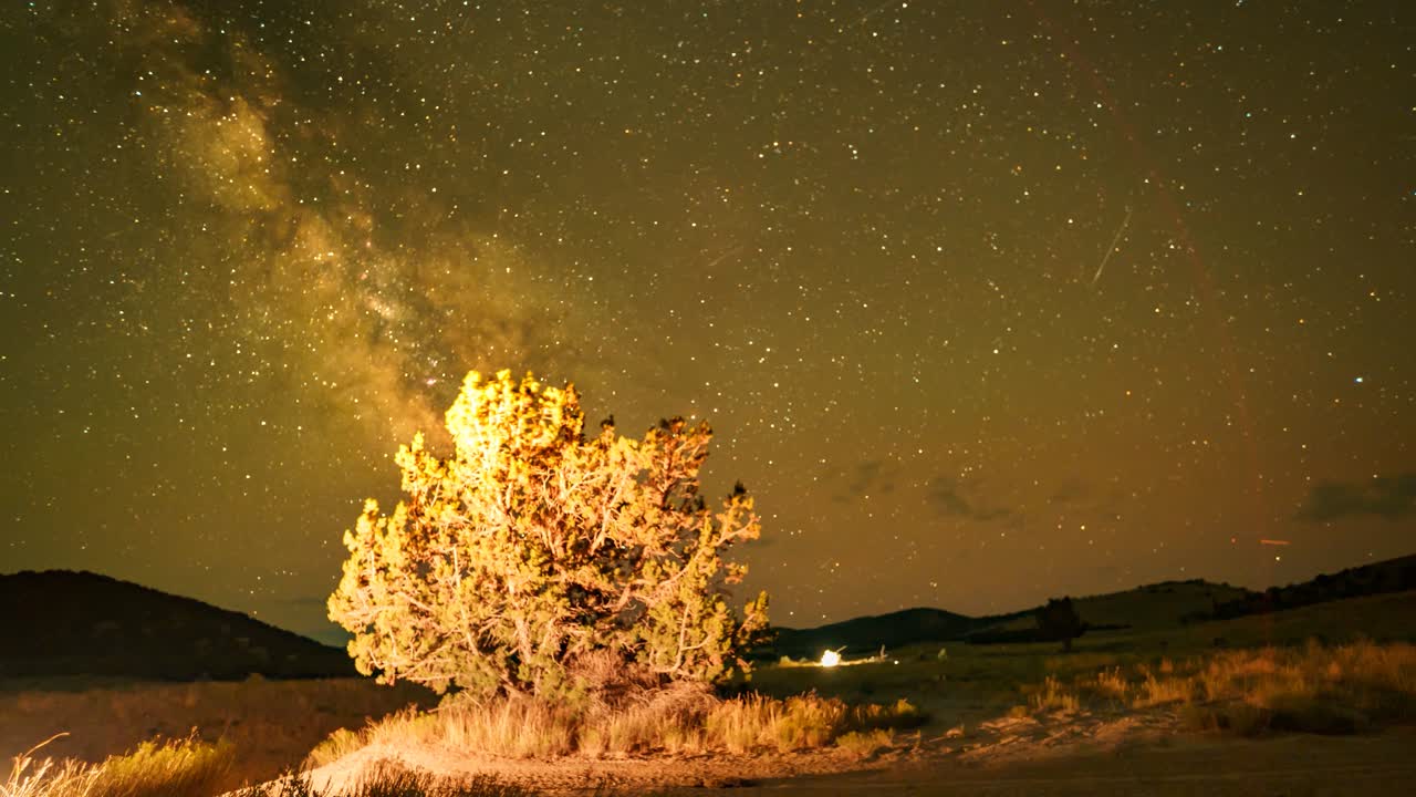 Sunset to Milky Way time lapse with a juniper tree in the foreground of Utah's West Desert landscape