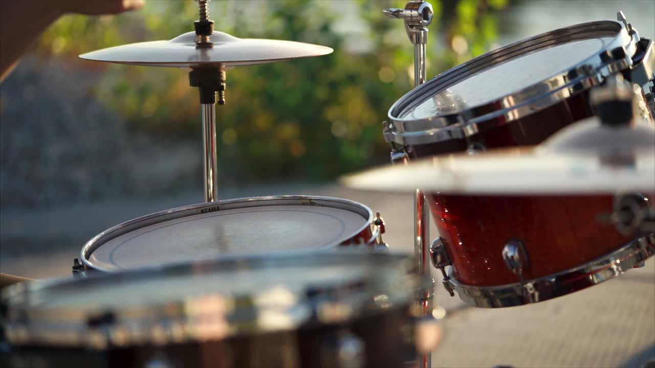 Drummer playing drums outdoors