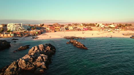 bahia inglesa beach aerial view circling rocky turquoise ocean coastline, coquimbo region of chile