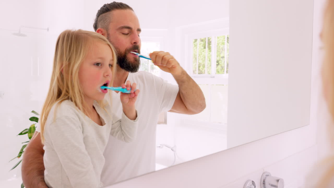 Father and Daughter Brushing Teeth